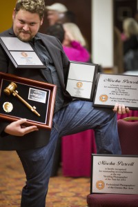 A respectable attempt to pose with all of his awards at once