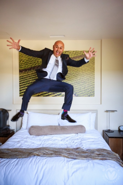 groom jumping on the bed