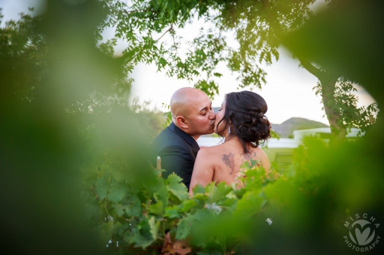 Bride & Groom kiss grapevines