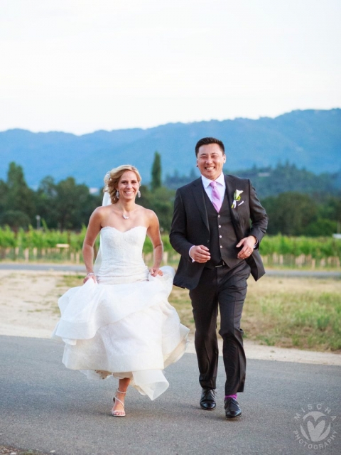 Bride & Groom running through vineyard